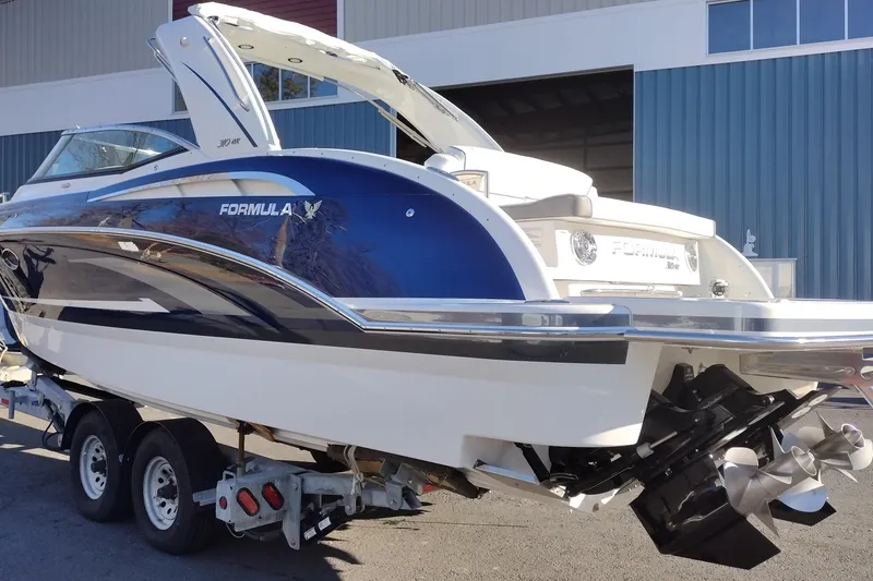 Slide: The Image of 2026 Formula 310 Bowrider boat with sleek blue and white design. - 8