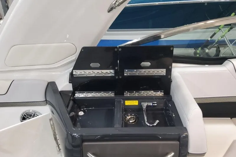 Slide: The Image of 2026 Formula 310 Bowrider boat interior with open storage compartment and sleek design. - 94