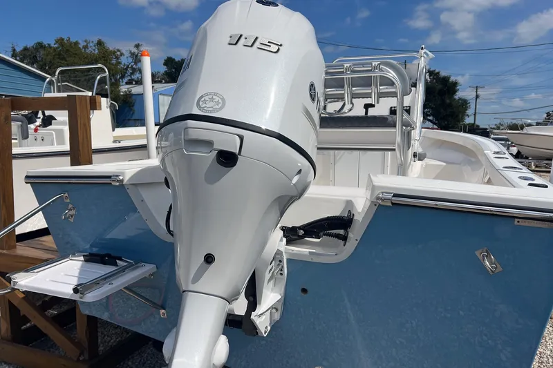 Slide: The Image of 2026 Defiance Catalina 190 boat with outboard motor, blue hull, and stainless steel fittings. - 19