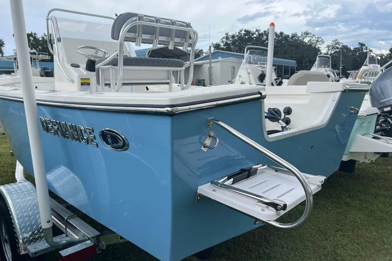 Slide: The Image of 2026 Defiance CATALINA 190 boat, blue exterior, rear view with ladder, parked on grass. - 4