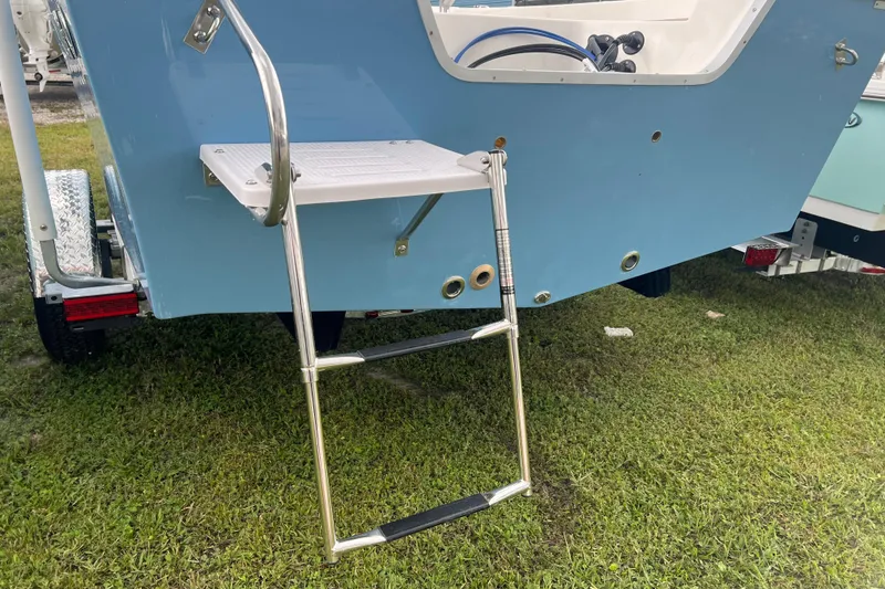 Slide: The Image of 2026 Defiance CATALINA 190 boat with rear ladder on grassy surface. - 5