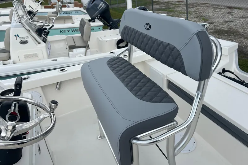 Slide: The Image of Defiance CATALINA 190 boat interior, featuring sleek gray seating and modern steering wheel, 2026 model. - 8