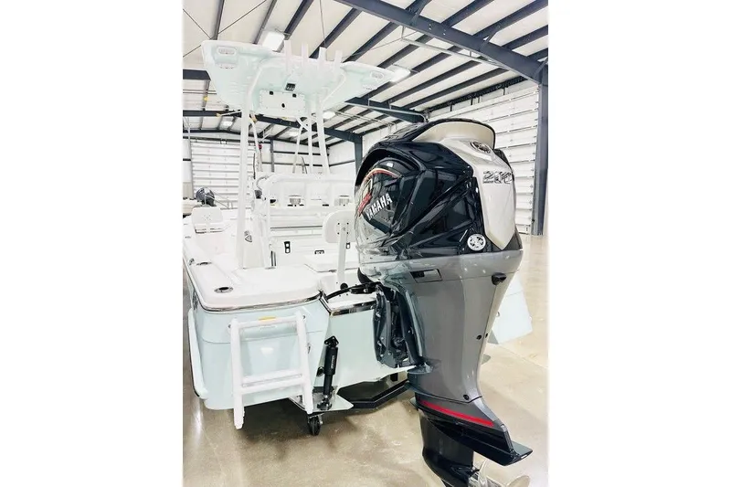 Slide: The Image of 2026 BlackJack 224 boat with Yamaha outboard motor in a warehouse setting. - 10
