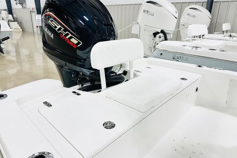 Slide: The Image of 2026 BlackJack 224 boat with Yamaha engine, white seating, and storage compartments. - 11