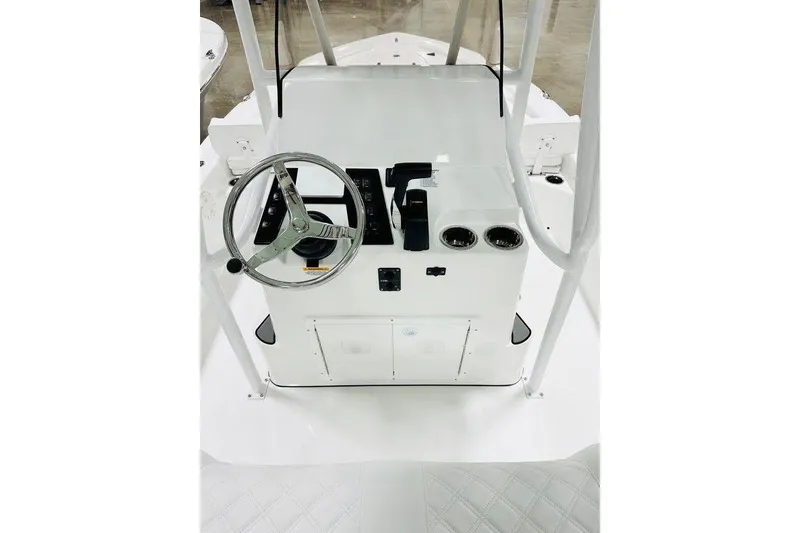 Slide: The Image of 2026 BlackJack 224 boat console with steering wheel and controls. - 2