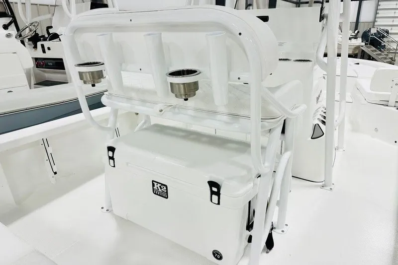 Slide: The Image of 2026 BlackJack 224 boat interior with rod holders and cooler storage. - 4