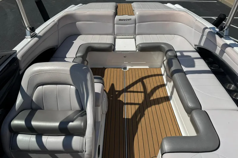 Slide: The Image of 2006 MasterCraft X-45 boat interior with gray seating and wood flooring. - 10