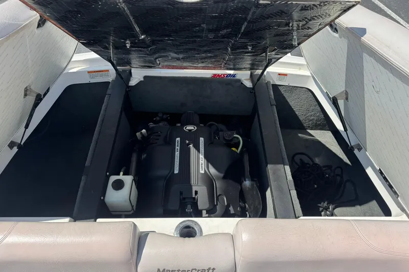 Slide: The Image of 2006 MasterCraft X-45 boat engine compartment with open hatch, showcasing engine and storage space. - 12