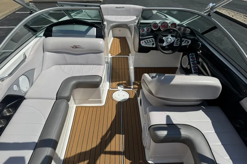 Slide: The Image of 2006 MasterCraft X-45 boat interior with white seating and wood flooring. - 13