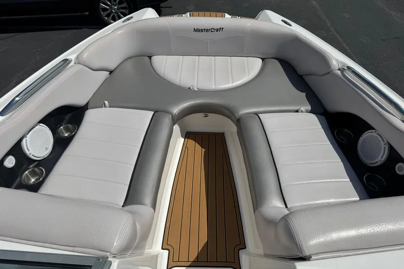 Slide: The Image of 2006 MasterCraft X-45 boat interior with gray seating and wood flooring. - 7