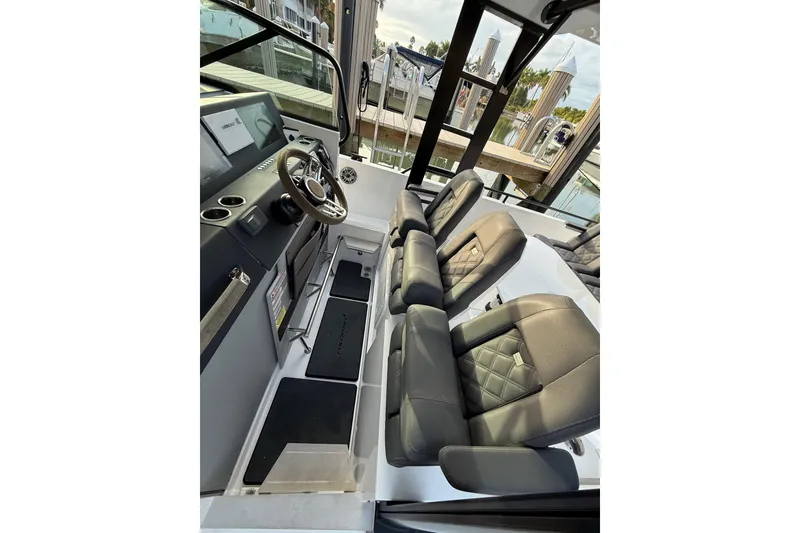 Slide: The Image of 2020 Axopar 37 Sun-Top boat docked, featuring sleek design and spacious seating. - 13