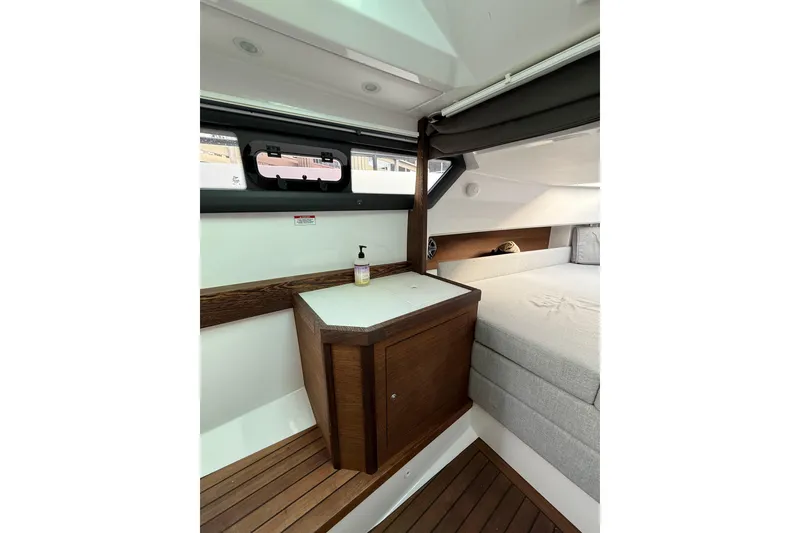 Slide: The Image of 2020 Axopar 37 Sun-Top boat docked, featuring sleek design and sunshade. - 14