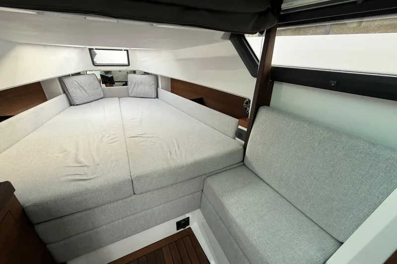 Slide: The Image of 2020 Axopar 37 Sun-Top boat interior with luxurious seating and modern dashboard. - 22