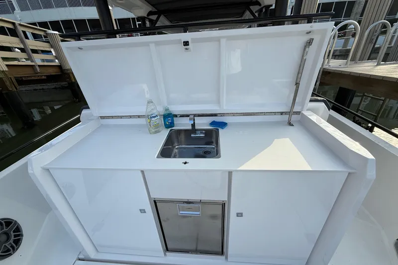 Slide: The Image of 2020 Axopar 37 Sun-Top boat interior with modern dashboard and seating. - 29