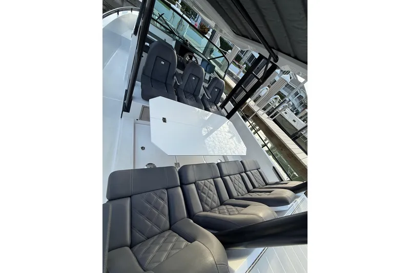 Slide: The Image of Interior of 2020 Axopar 37 Sun-Top boat with luxurious seating and modern dashboard. - 32