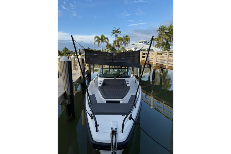 Slide: The Image of 2020 Axopar 37 Sun-Top boat docked, featuring sleek design and spacious seating. - 33