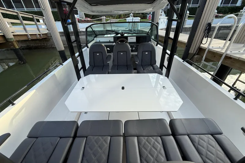 Slide: The Image of 2020 Axopar 37 Sun-Top interior with modern seating and steering wheel. - 37