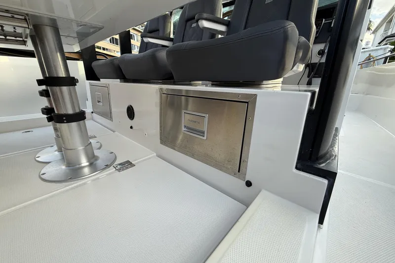 Slide: The Image of 2020 Axopar 37 Sun-Top boat docked, featuring sleek design and spacious seating. - 38