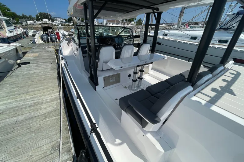 Slide: The Image of 2020 Axopar 37 SUN TOP BRABUS boat with seating, docked in a marina. - 7