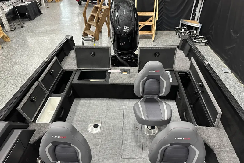 Slide: The Image of 2026 Alumacraft Competitor 185X Side Console interior with seating and storage compartments. - 12