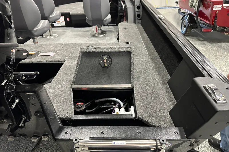 Slide: The Image of 2026 Alumacraft Competitor 185X Side Console interior with open storage compartment and seating. - 14