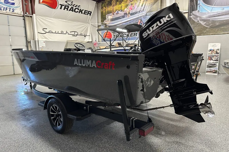 Slide: The Image of 2026 Alumacraft Competitor 185X Side Console boat with Suzuki engine in showroom. - 4