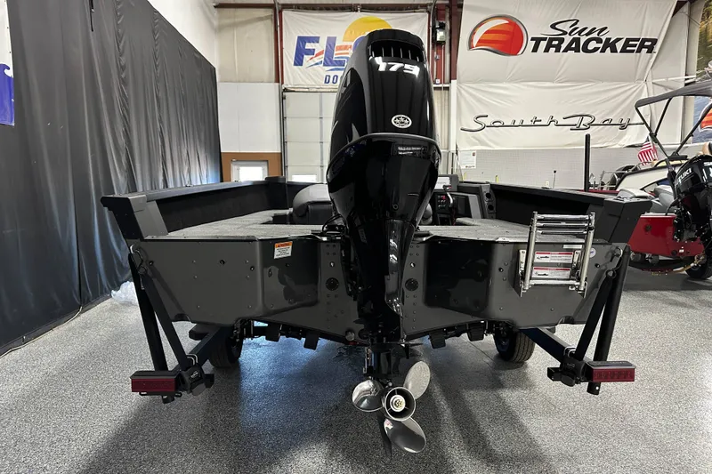 Slide: The Image of 2026 Alumacraft Competitor 185X Side Console boat with 175 HP engine in showroom. - 5