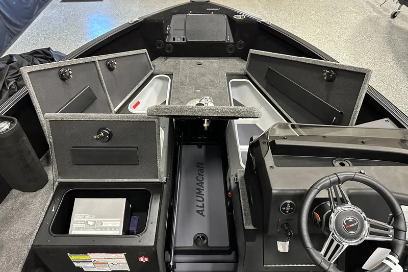 Slide: The Image of 2026 Alumacraft Competitor 185X Side Console boat interior with open storage compartments. - 9
