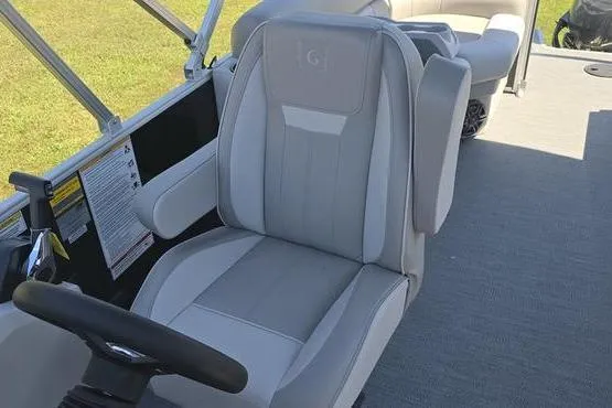 Slide: The Image of 2026 Godfrey Xperience 2286 SBX Sport Tube interior with plush captain's chair and steering wheel. - 14