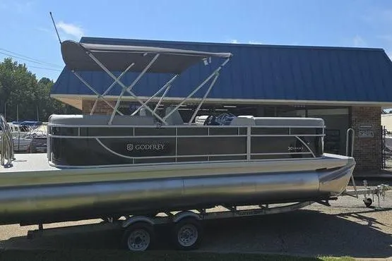 Slide: The Image of 2026 Godfrey Xperience 2286 SBX Sport Tube pontoon boat on trailer, parked outdoors. - 5