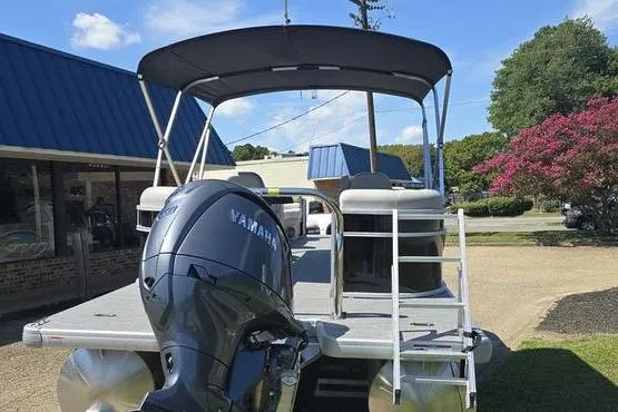 Slide: The Image of 2026 Godfrey Xperience 2286 SBX pontoon boat with Yamaha motor, parked outdoors. - 6