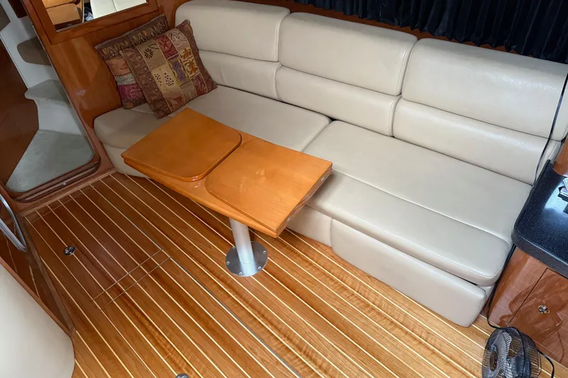Slide: The Image of Luxurious interior of 2007 Regal Commodore 3760 IO with leather seating and wooden table. - 11