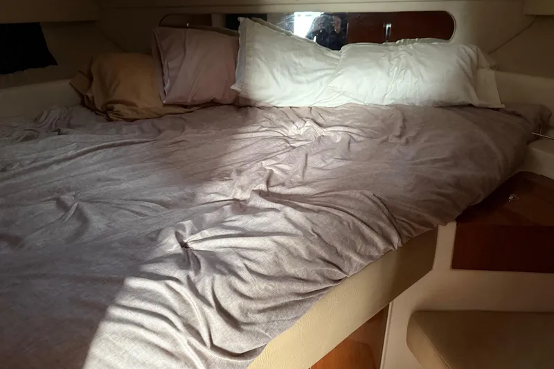 Slide: The Image of Cozy cabin bed inside 2007 Regal Commodore 3760 IO yacht with soft pillows and bedding. - 12