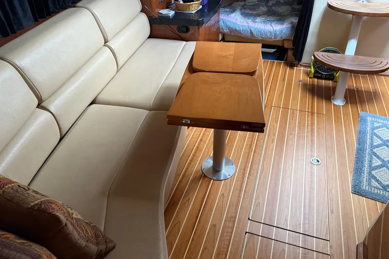 Slide: The Image of 2007 Regal Commodore 3760 IO interior with beige seating and wooden flooring. - 13