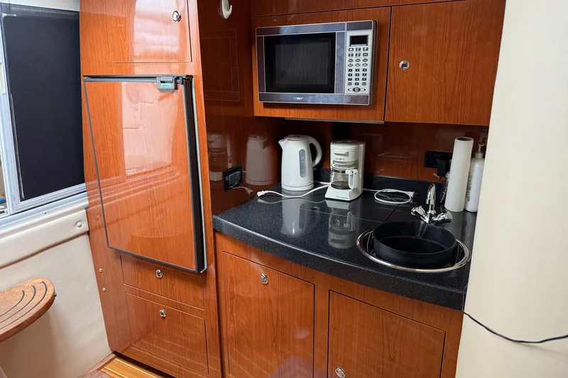 Slide: The Image of 2007 Regal Commodore 3760 IO yacht kitchen with microwave, fridge, and sink. - 14