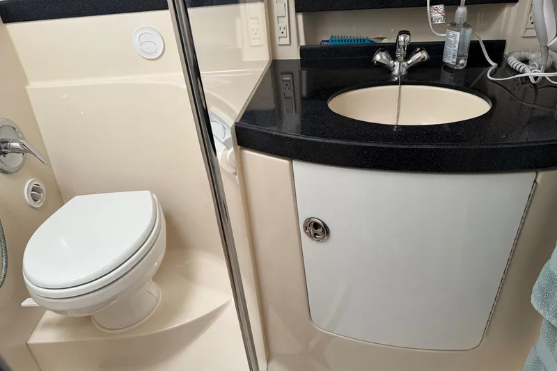 Slide: The Image of 2007 Regal Commodore 3760 IO bathroom with toilet and sink, featuring modern fixtures. - 15