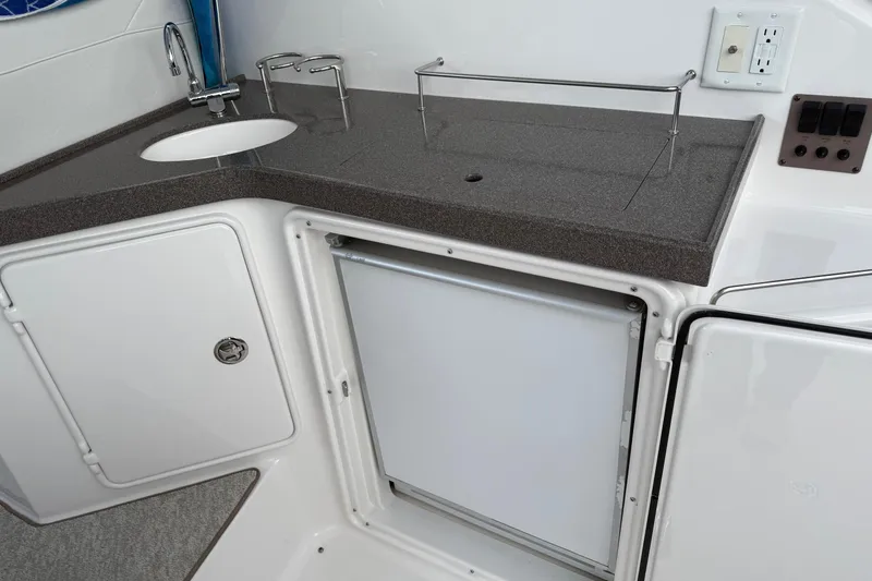 Slide: The Image of 2007 Regal Commodore 3760 IO boat kitchenette with sink, countertop, and storage cabinets. - 17