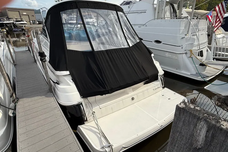 Slide: The Image of 2007 Regal Commodore 3760 IO boat docked with black canopy cover. - 3