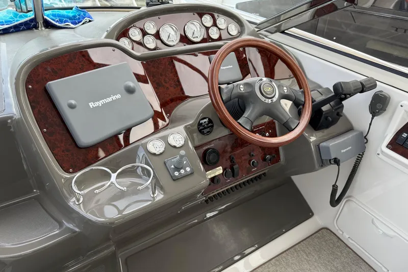 Slide: The Image of 2007 Regal Commodore 3760 IO boat dashboard with wood accents and Raymarine equipment. - 6
