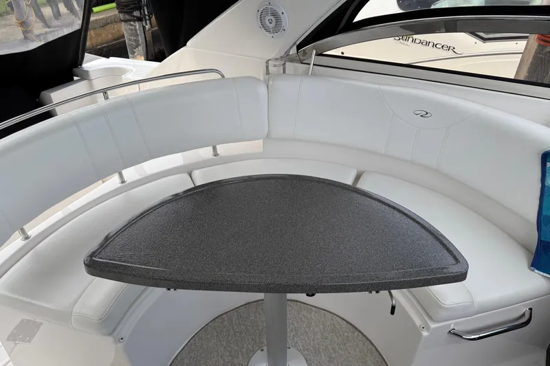 Slide: The Image of 2007 Regal Commodore 3760 IO boat interior with white seating and a triangular table. - 7
