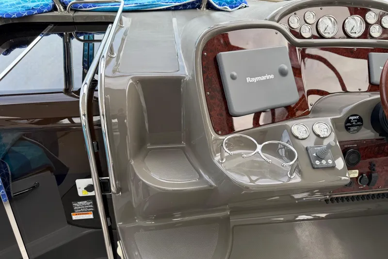 Slide: The Image of 2007 Regal Commodore 3760 IO dashboard with Raymarine navigation system and controls. - 8