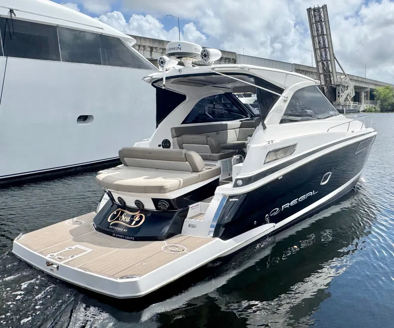 The Image of 2015 Regal 35 Sport Coupe yacht docked, featuring sleek design and spacious seating. - 0