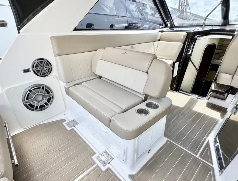 Slide: The Image of 2015 Regal 35 Sport Coupe interior with beige seating and cup holders. - 12
