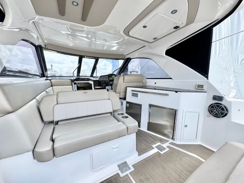 Slide: The Image of Interior of 2015 Regal 35 Sport Coupe with luxurious seating and modern amenities. - 13