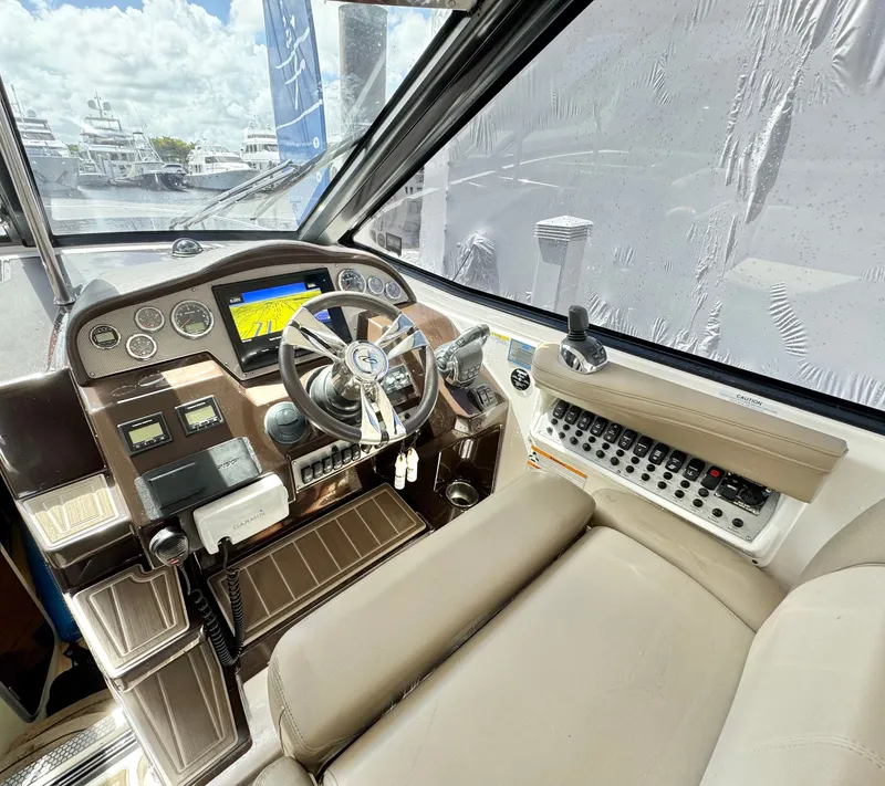 Slide: The Image of Cockpit of 2015 Regal 35 Sport Coupe with steering wheel and control panel. - 19