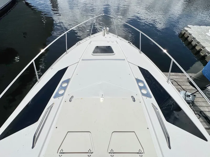 Slide: The Image of 2015 Regal 35 Sport Coupe boat deck view at marina. - 27