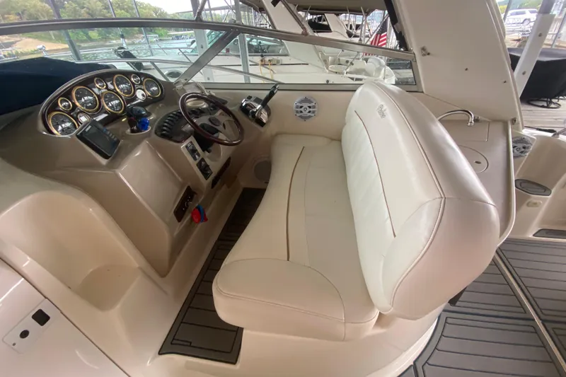 Slide: The Image of 2002 Rinker 342 Fiesta Vee boat interior with steering console and white seating. - 11
