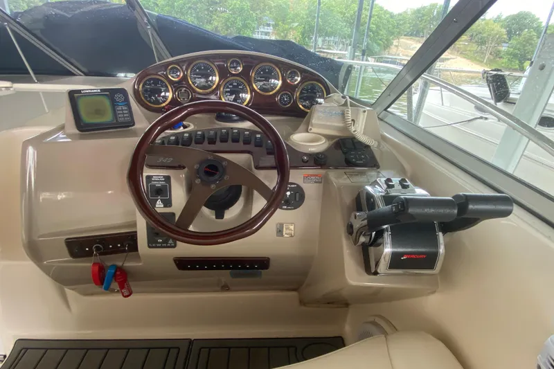 Slide: The Image of 2002 Rinker 342 Fiesta Vee boat helm with steering wheel and control panel. - 12
