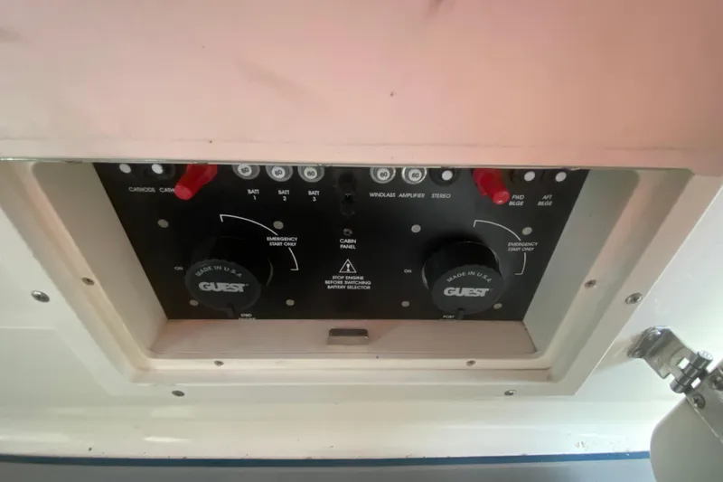 Slide: The Image of Control panel of a 2002 Rinker 342 Fiesta Vee boat, featuring various switches and knobs. - 13