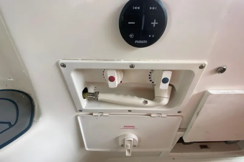 Slide: The Image of Control panel and shower handle on a 2002 Rinker 342 Fiesta Vee boat. - 14